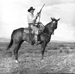 Alfred Gillette Means on Horseback with Rifle